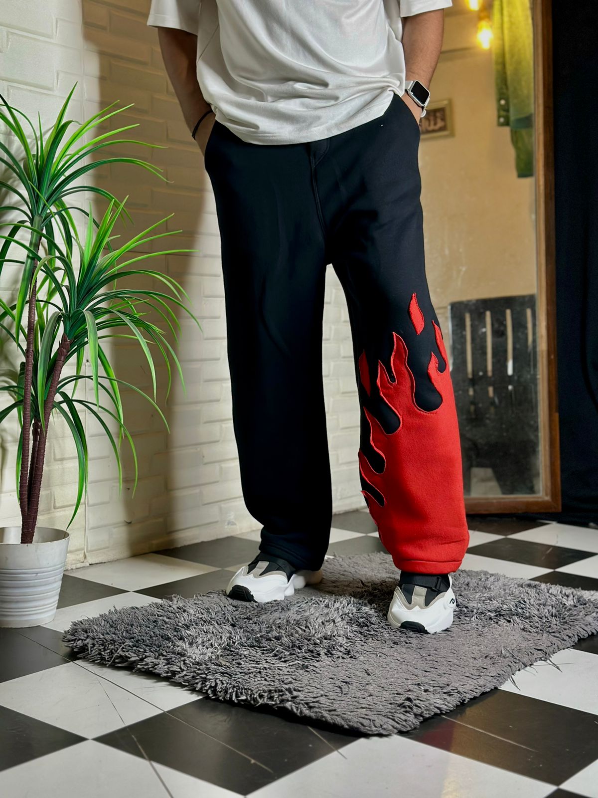 Walking shot of Fire Kick Bottom Pant in motion – wide-leg flame stitch streetwear

